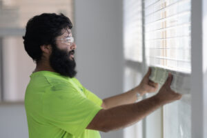 Technician installing blinds